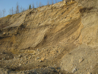 Photo of the quarry for the extraction of gold. A large pile of rubble sand and clay saturated with...