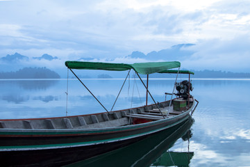 Long tail boat in the early morning at Cheow Larn Lake , Khao Sok National Park  Surat Thani Thailand