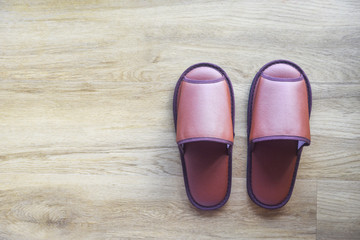 Brown slippers on the wooden floor / home slippers