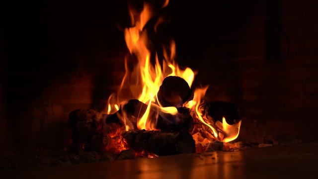 Perspective Shot Of Fire In A Fireplace, Embers For Cooking And For Heating The Home In Winter