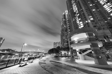 Fototapeta na wymiar Promenade and high rise residential building in Hong Kong city at night