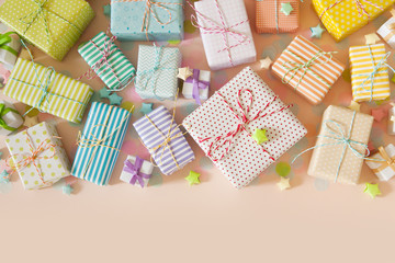Gift boxes and pastel color confetti. Pink background.