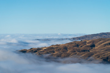 New Zealand landscape of Otago backcountry with mountains and clouds