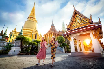 Fotobehang Bangkok Asian girl walk in Wat phra kaew and grand palace travel in Bangkok city