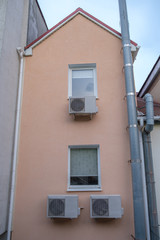The facade of the building with windows and air conditioning.