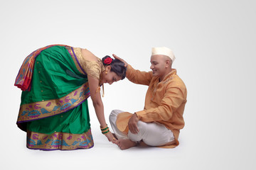 Hindu female touching his feet due respect with hands - Image.