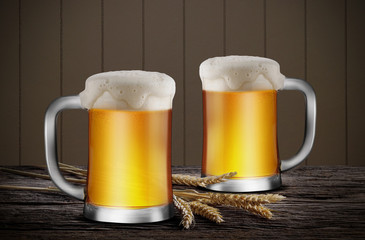 Glasses of Light Beer with wheat on the wooden table in dark background, with copy space for your text