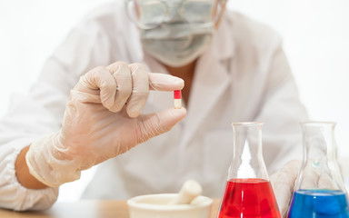 Tablets capsules in the hands of scientists working in laboratories