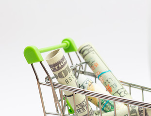 money bank in shopping cart on white isolate background,