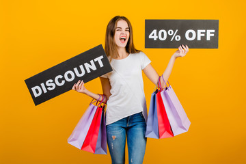 beautiful brunette woman with colorful shopping bags and copyspace text discount 40% sign isolated over yellow