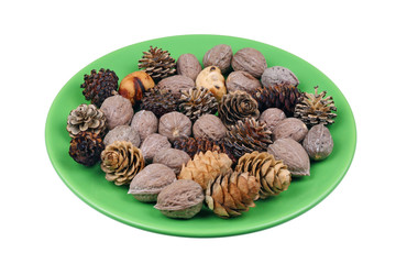 Fototapeta na wymiar Beautiful fir and pine trees cones and forest nuts heap for the Christmas wreath isolated macro