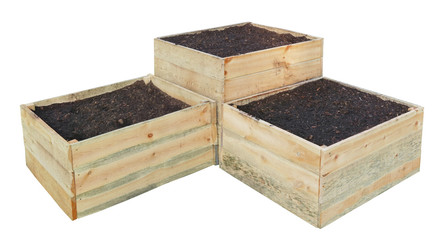 THree new wooden boxes filled with compost and soil for growing decorative plants isolated