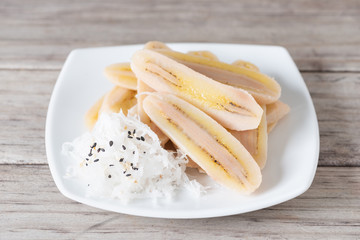 Boiled slice banana eat with coconut