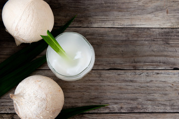 Fresh coconut juice in a glass with coconut white meat isolated on white