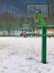 Basketball  field covered with snow, in Agios Nikolaos (Saint Nicholas) park in Naousa Greece.