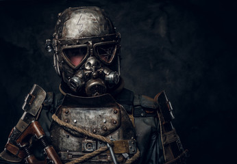 Unusual costume for Halloween - dark apocalypse warrior in metal gas mask.