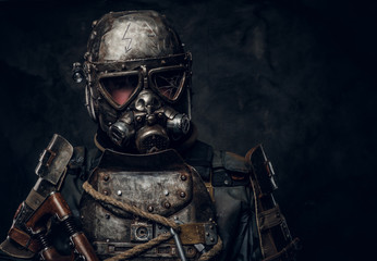 Fototapeta premium Unusual costume for Halloween - dark apocalypse warrior in metal gas mask.