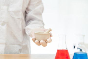 Scientists grinding medicine in a lab on white background,