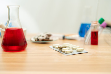 Blurred Capsule medicine on the table with in a lab room background,
