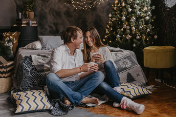 Romantic couple in love feeling happiness about their romance spending christmas eve together- Image