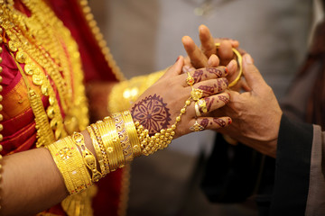 indian bride getting her wedding bangles