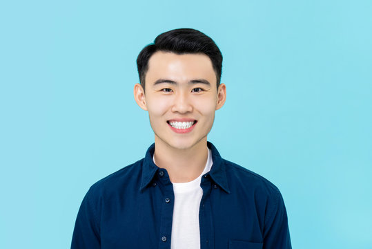 Portrait of  smiling young Asian man in plain casual clothes