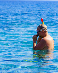 Man with snorkeling tube in sea