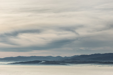 A view of Umbria valley with hills and fog