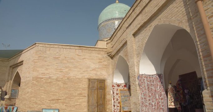 Muslim religious complex, mausoleum Hazrati Imam in Tashkent, Uzbekistan. The minarets that are close to the mosque about 50 meters high. Part of the medrese is now occupied by artisans. BMPCC4K