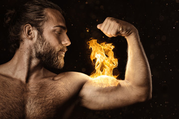 Strong man with a biceps on fire