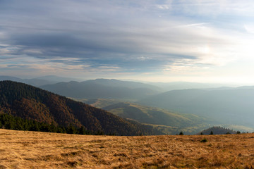 Beautiful sunset and layered mountain silhouettes in evening