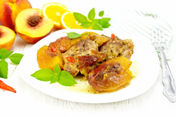 Turkey with peaches in plate on light board