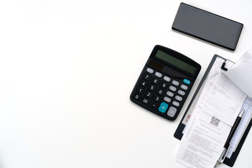Office work table with bill, mobile phone, and calculator on white table , Top view, copy space for text message
