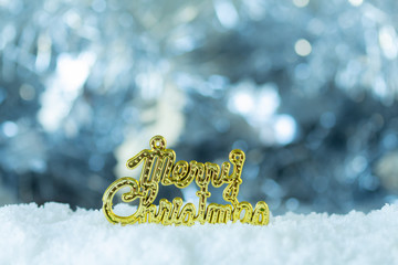 Gold Merry Christmas on light bokeh background,