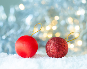 Red ball in the snow on white bokeh background,