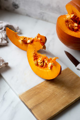 pumpkins with cinnamon sticks on marble backgrund