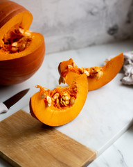 pumpkins with cinnamon sticks on marble backgrund