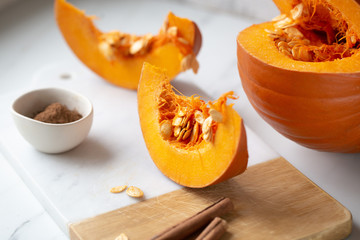 pumpkins with cinnamon sticks on marble backgrund