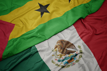 waving colorful flag of mexico and national flag of sao tome and principe . macro