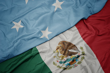 waving colorful flag of mexico and national flag of Federated States of Micronesia . macro
