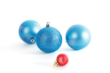 Christmas decorative three christmas blue balls and one red christmas ball on white background