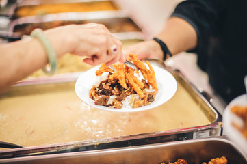 Volunteers are donating free charity food to homeless beggars: the concept of food needs in society.