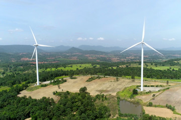 Fototapeta na wymiar Wind turbine is alternative electrical power with blue sky, summer field, renewable energy
