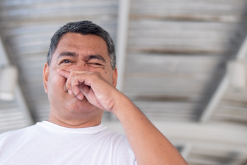 allergic sick old man having cold, flu, allergy with runny nose