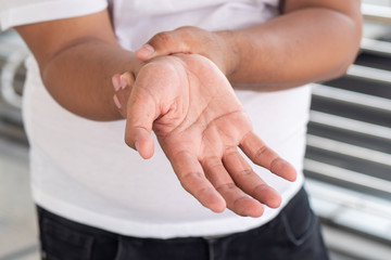 old senior man suffering from trigger finger, cps or carpal tunnel syndrome, gout disease,...