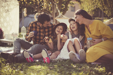 Family is the meaning of life. Parents with daughters in nature.