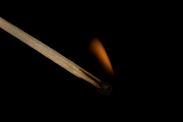 burning match on black background
