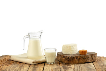 Different milk products, cheese, cream, milk on wooden table and white background. Healthy eating...