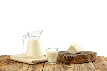 Different milk products, cheese, cream, milk on wooden table and white background. Healthy eating and lifestyle, organic natural nutrition, diet. Delicious food and drinks.