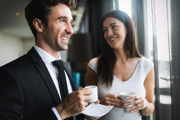 Young couple of professionals chatting during a coffee break
